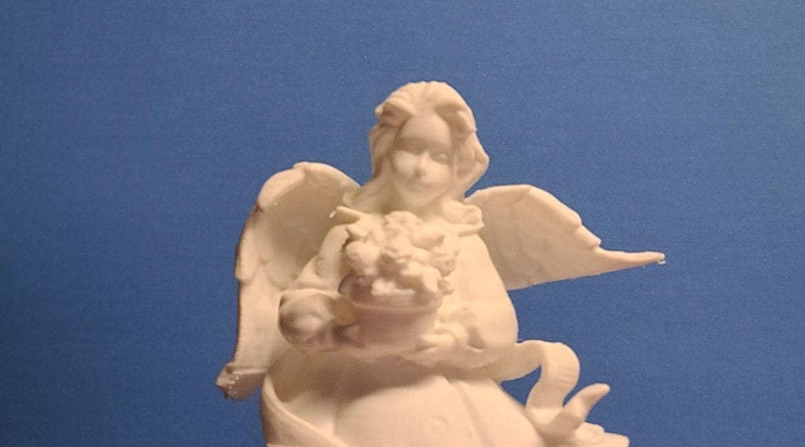 Statuette of Angel carrying a bouquet of flowers