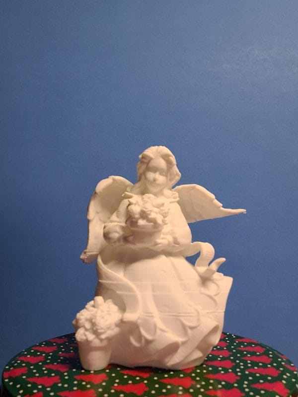 Statuette of Angel carrying a bouquet of flowers